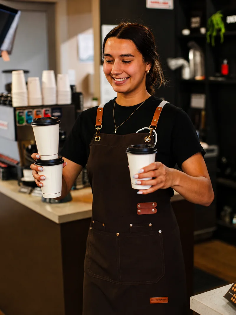 Cafe Jireh team member preparing takeaway coffee