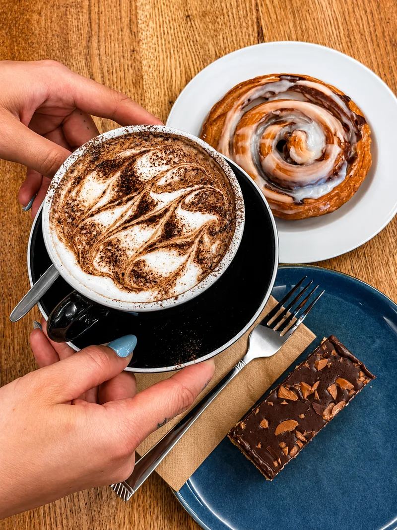 Coffee, a cinnamon scroll and chocolate slice at Cafe Jireh